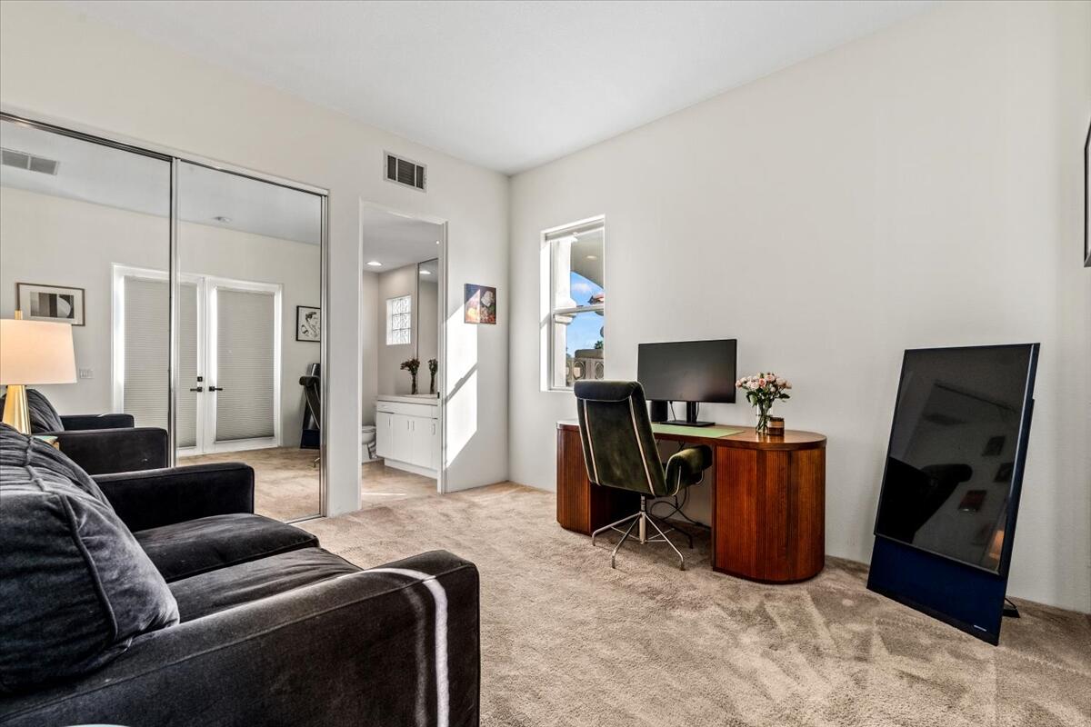 54695 Winged Foot La Quinta, CA 92253 - Photo 39 of 51 a living room with furniture a flat screen tv and a refrigerator