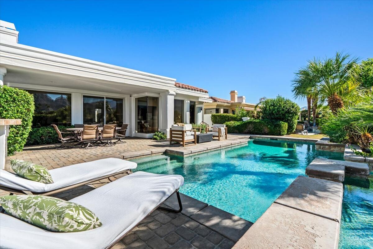 54695 Winged Foot La Quinta, CA 92253 - Photo 47 of 51 a view of a patio with couches table and chairs with plants and wooden fence