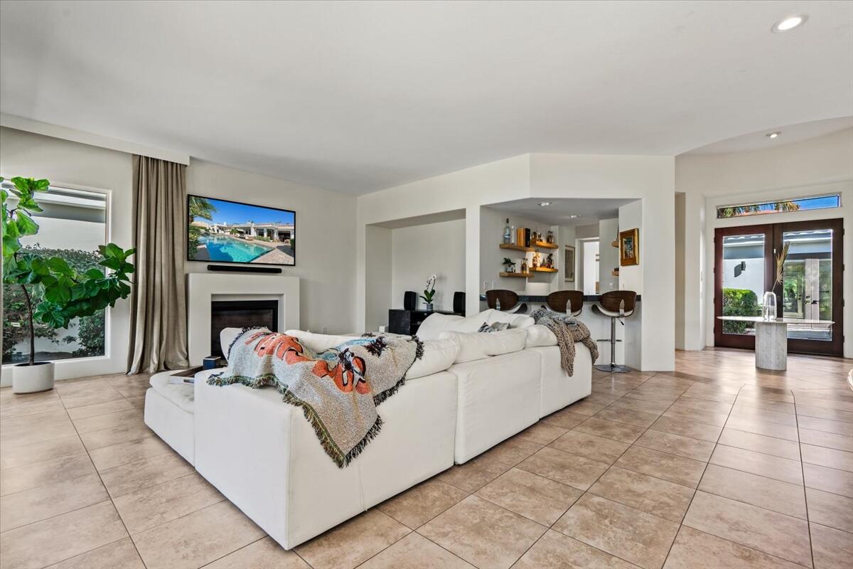 54695 Winged Foot La Quinta, CA 92253 - Photo 6 of 51 a living room with furniture a fireplace and potted plants