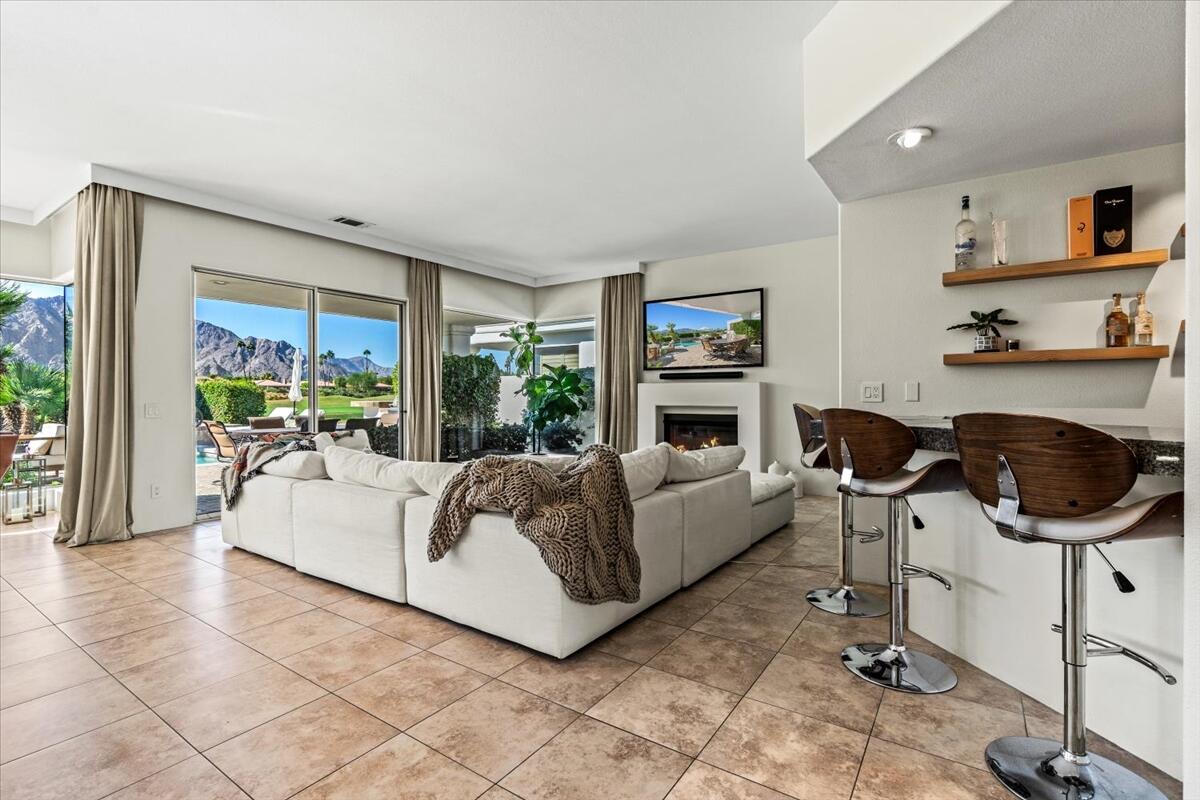 54695 Winged Foot La Quinta, CA 92253 - Photo 7 of 51 a living room with furniture a large window and a fireplace