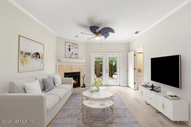 a living room with furniture a flat screen tv and a fireplace