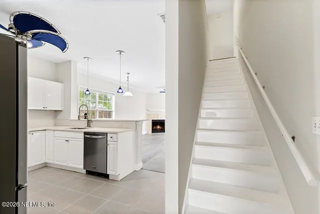 a view of an empty room with window and fire place