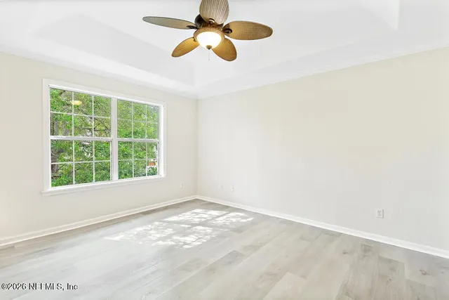 a view of a room with a window and a ceiling fan