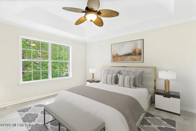 a bedroom with a large bed and a window