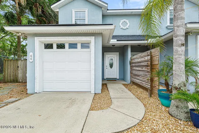 a view of a hallway with white walls and stairs
