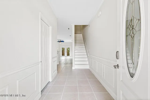 an empty room with wooden floor a fireplace and windows