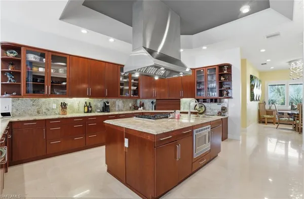 a kitchen with stainless steel appliances granite countertop a sink and a stove