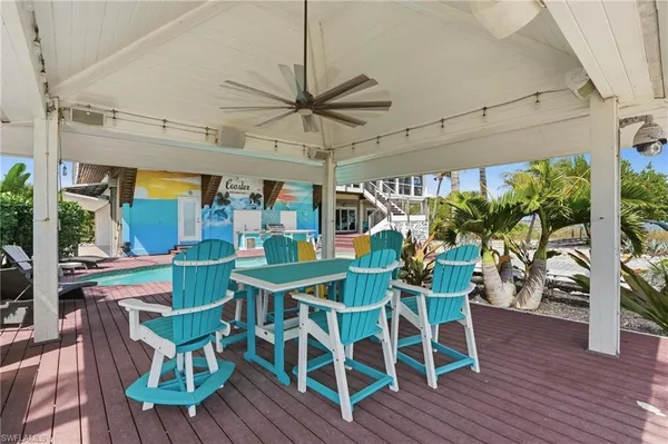 a view of swimming pool with outdoor seating and wooden floor