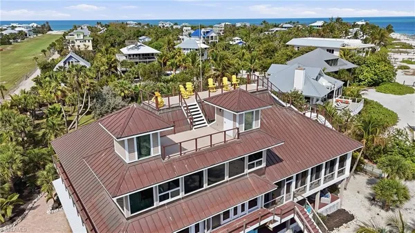 a palm tree sitting in front of a house