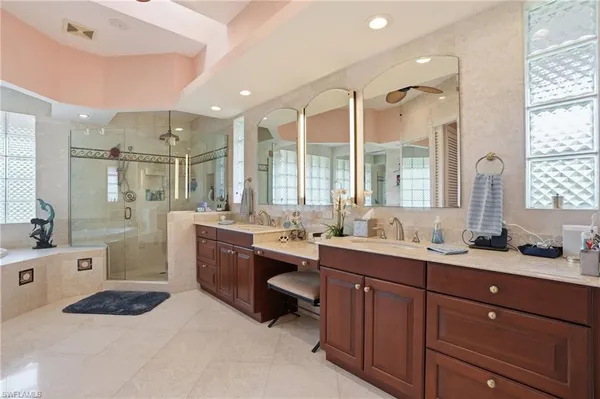 a spacious bathroom with a double vanity sink mirror and double