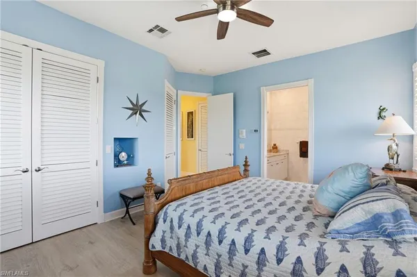 a bedroom with a bed and a chandelier