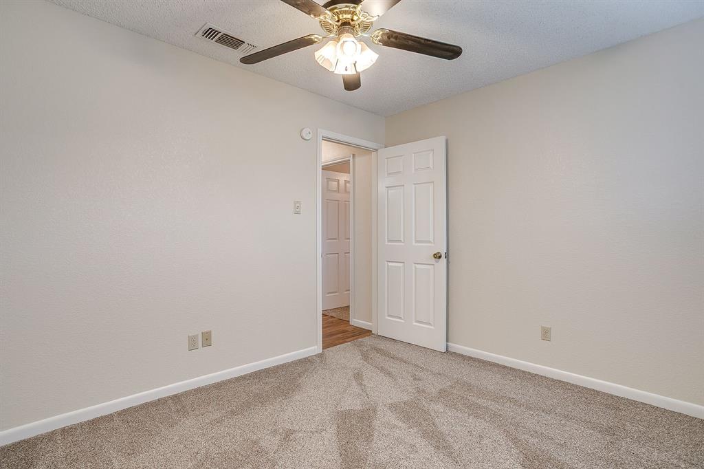 8613 Silver Creek Road White Settlement, TX 76108 - Photo 24 of 40 a view of an empty room and chandelier fan
