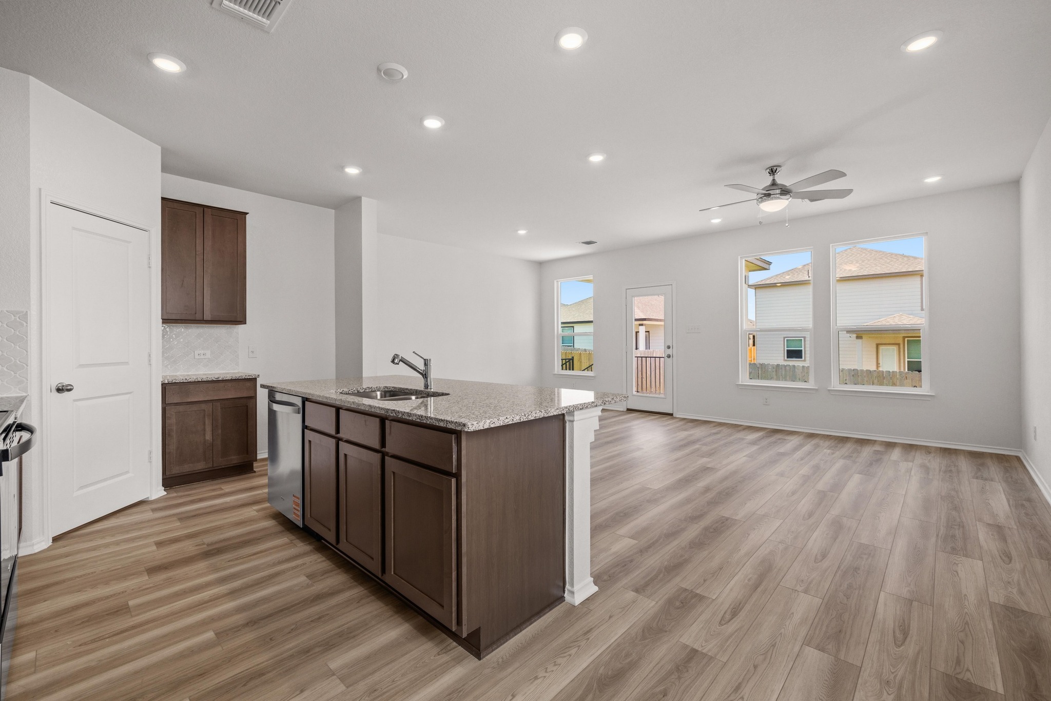 260 Feathers Street Jarrell, TX 76537 - Photo 8 of 34 a kitchen with stainless steel appliances granite countertop a sink a stove and a wooden floors