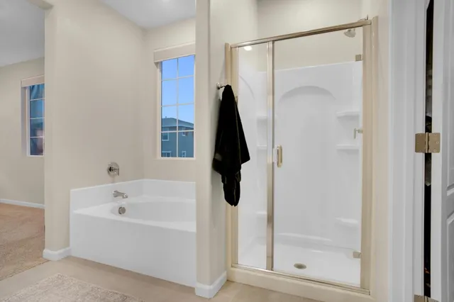 a white bath tub sitting next to a shower