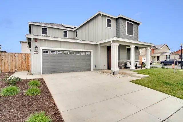 a front view of a house with a yard and garage