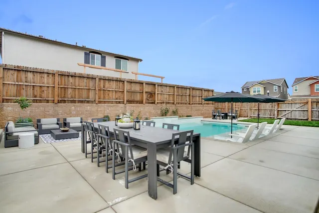 a roof deck with a table and chairs