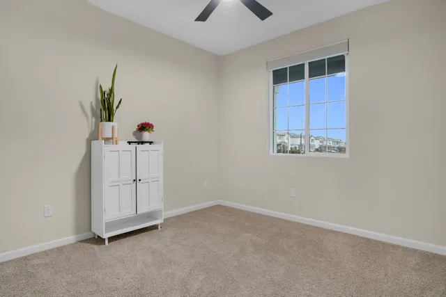 an empty room with windows and cabinet