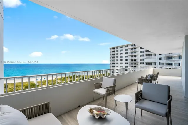 a view of a chair and tables in the balcony
