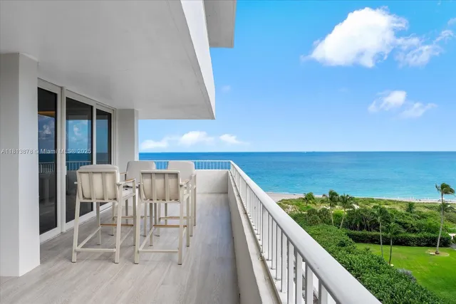 a view of a balcony with chair and wooden floor