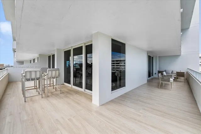 a view of a room with furniture and wooden floor