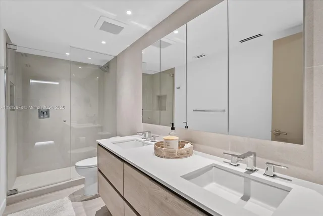 a bathroom with a sink double vanity and shower