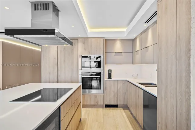 a kitchen with granite countertop a sink stove and refrigerator