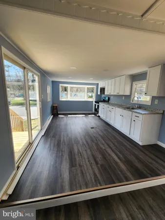 a kitchen with wooden floors and sink