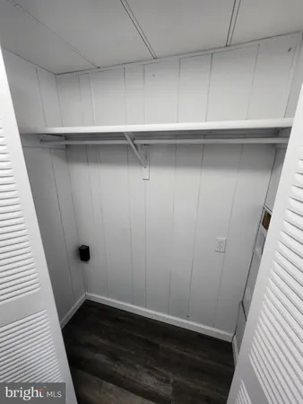 a view of storage and utility room with wooden floor
