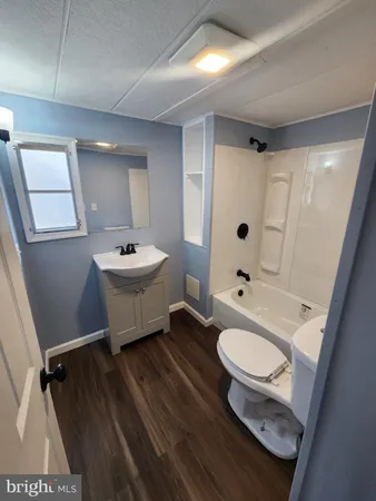 a bathroom with a sink toilet a mirror and shower