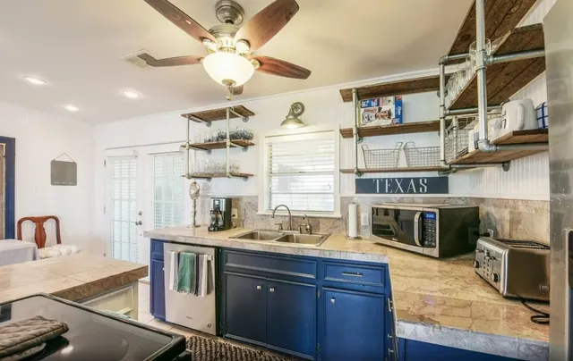 a kitchen with stainless steel appliances granite countertop a stove and cabinets