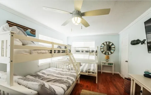 a bedroom with a bed and a wooden floor