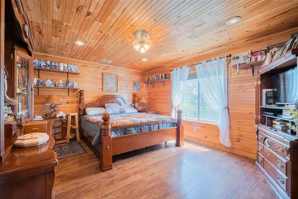 a bedroom with furniture and a book shelf