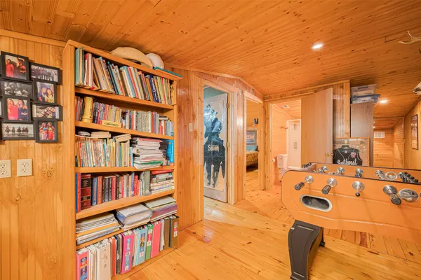 a living room with lots of furniture and baby book shelf