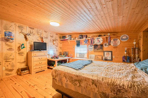 a bedroom with a bed and flat screen tv