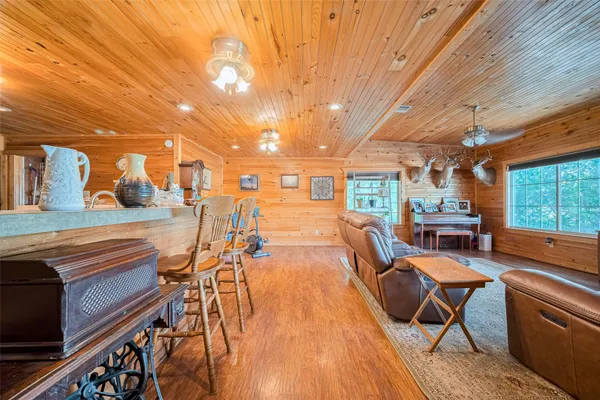 a dining room with furniture and wooden floor