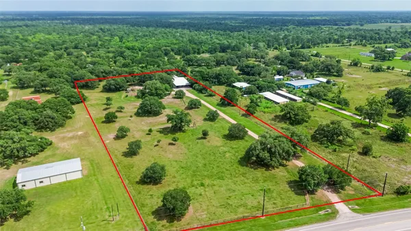 a view of a big yard with lots of green space