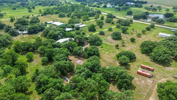 an aerial view of residential houses with outdoor space and street view