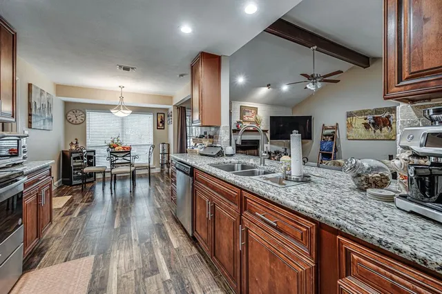 a kitchen with lots of counter top space and wooden floor