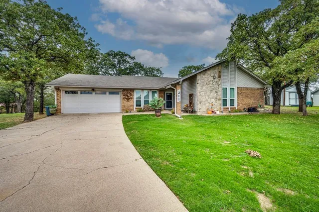 a front view of house with yard and green space
