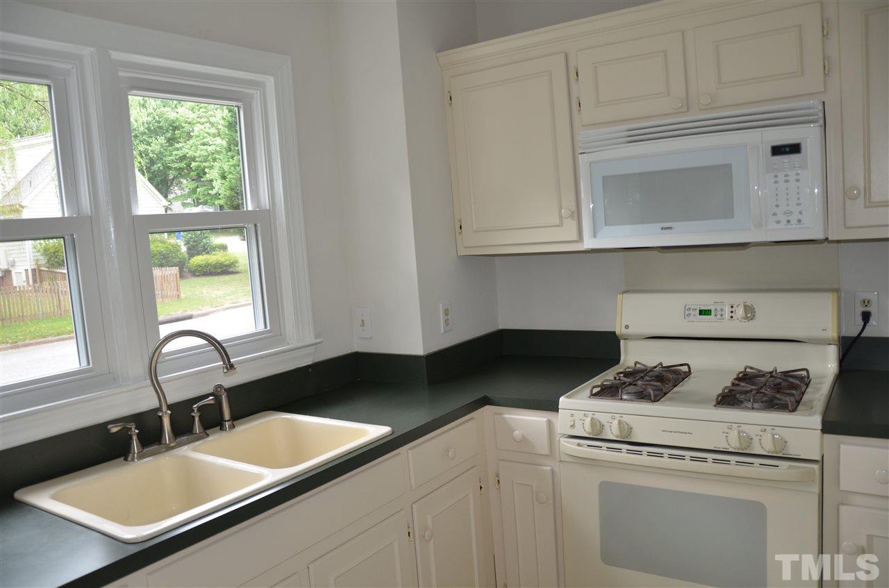 8816 Life Lane Raleigh, NC 27615 - Photo 13 of 25 a kitchen with granite countertop white cabinets and a stove