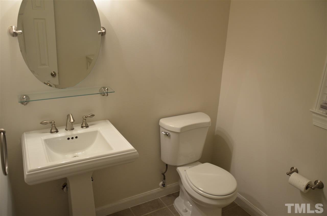 8816 Life Lane Raleigh, NC 27615 - Photo 15 of 25 a white toilet sitting next to a bathroom sink