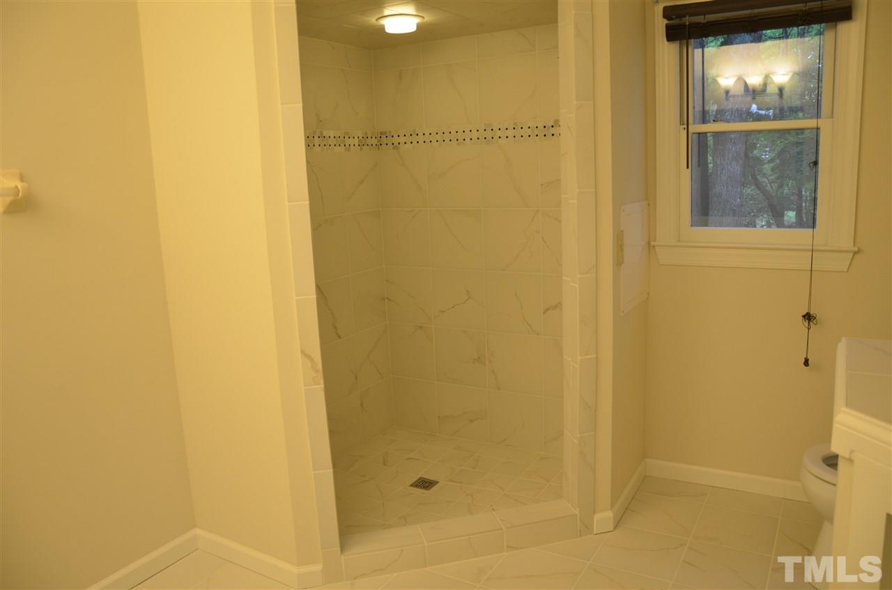 8816 Life Lane Raleigh, NC 27615 - Photo 18 of 25 a bathroom with a shower