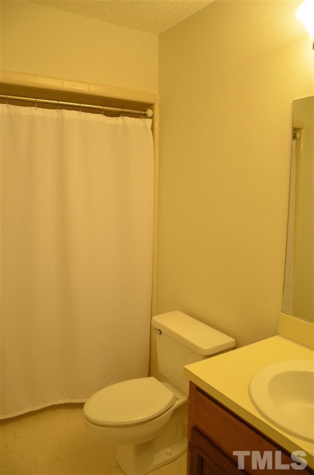 8816 Life Lane Raleigh, NC 27615 - Photo 21 of 25 a bathroom with a sink and a toilet