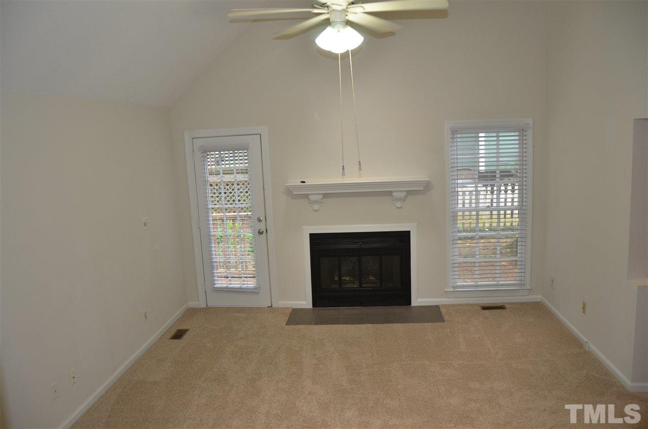 8816 Life Lane Raleigh, NC 27615 - Photo 6 of 25 a view of a livingroom with a fireplace and a window