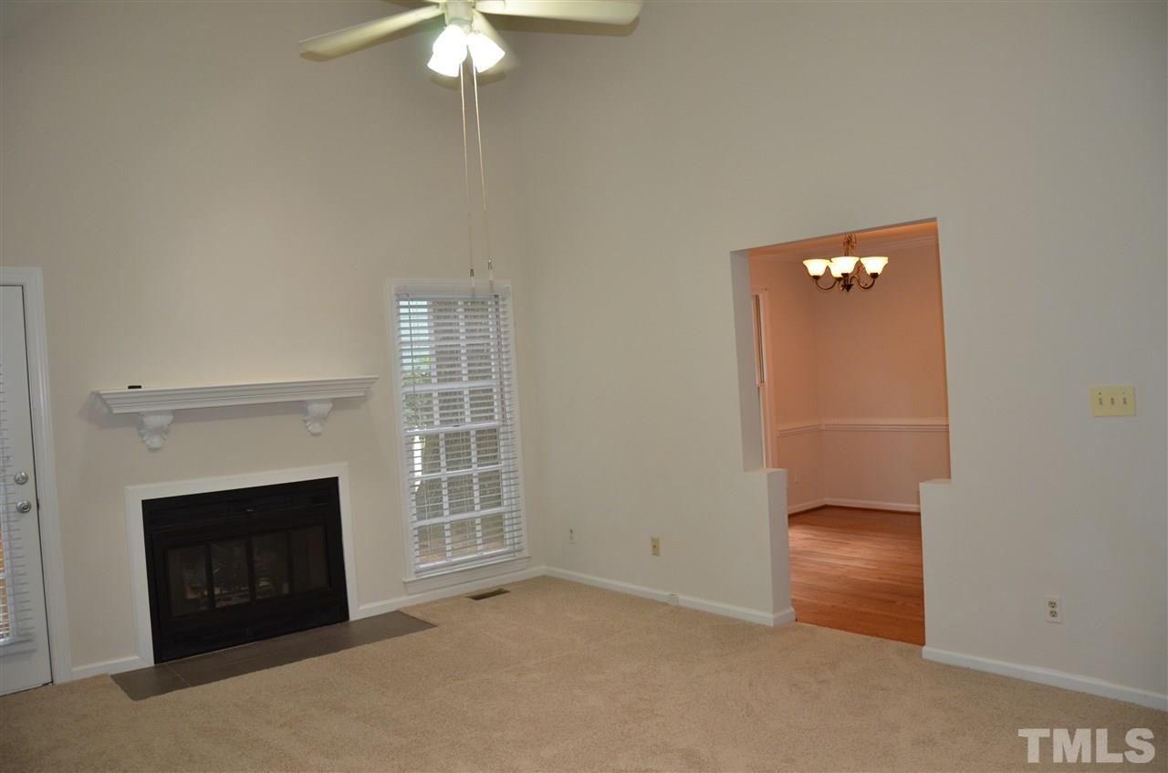 8816 Life Lane Raleigh, NC 27615 - Photo 7 of 25 an empty room with a fireplace