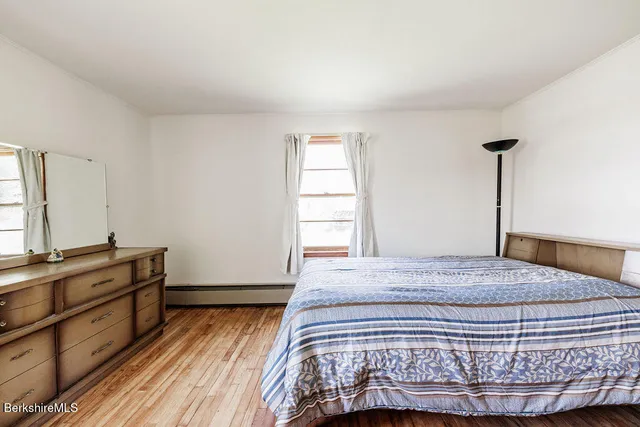 a living room with furniture a rug and a window