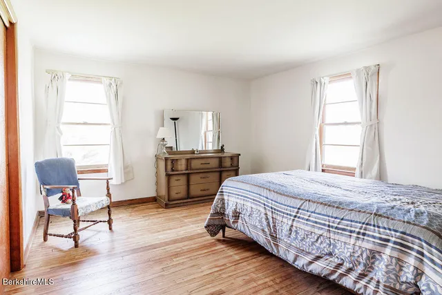 a bedroom with furniture and a window