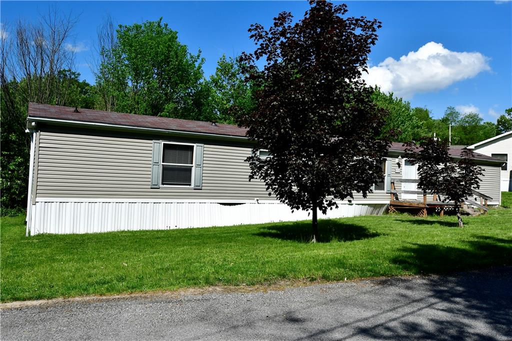 604 Deana Way Rochester, PA 15074 - Photo 3 of 22 a front view of a house with a garden and trees