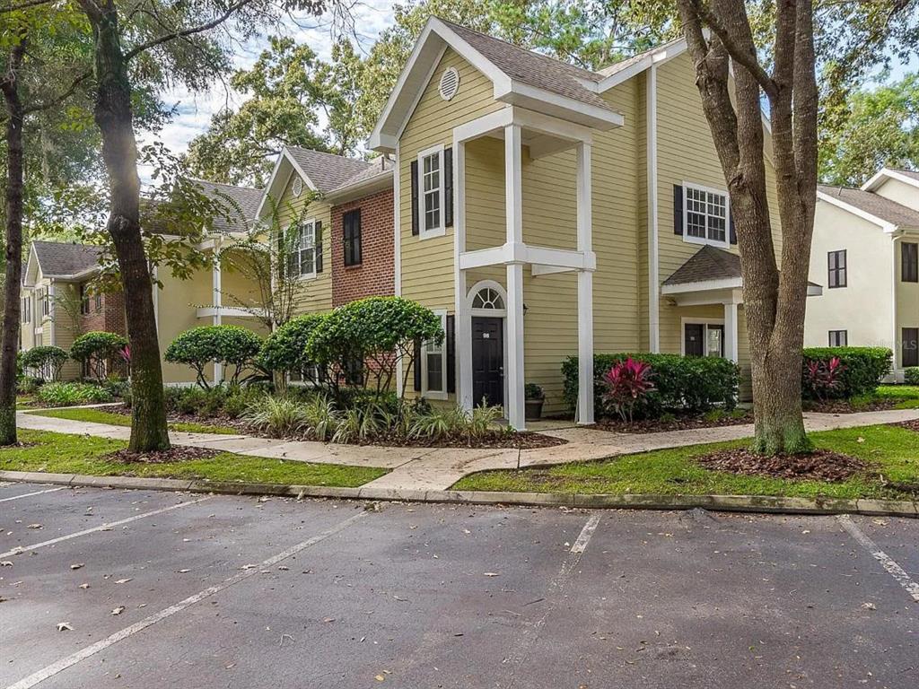 10000 Southwest 52nd Avenue, Unit 99 Gainesville, FL 32608 - Photo 1 of 19 a front view of a house with a yard and trees