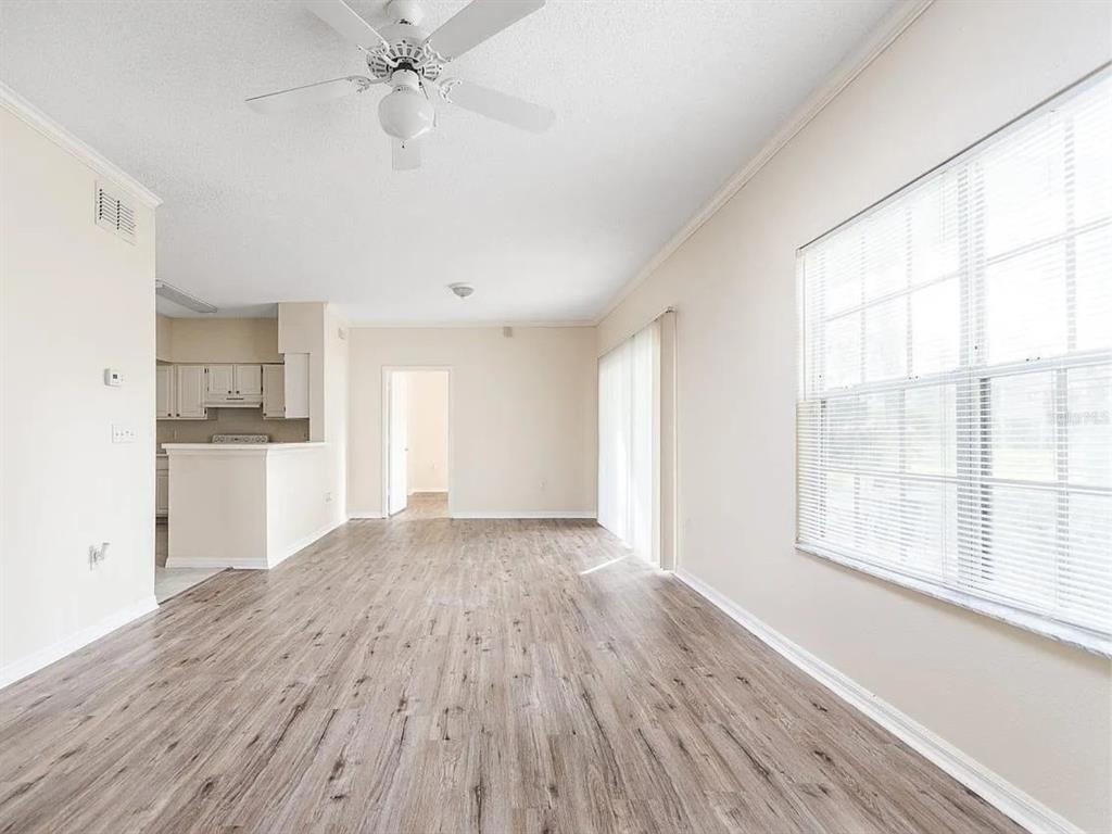 10000 Southwest 52nd Avenue, Unit 99 Gainesville, FL 32608 - Photo 4 of 19 a view of a kitchen with wooden floor and a kitchen